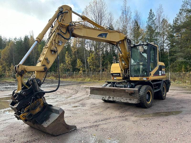 Caterpillar M312 Engcon EC20 tiltrotator - Τροχοφόρος εκσκαφέας: φωτογραφία 1 Caterpillar M312 Engcon EC20 tiltrotator - Τροχοφόρος εκσκαφέας: φωτογραφία 1