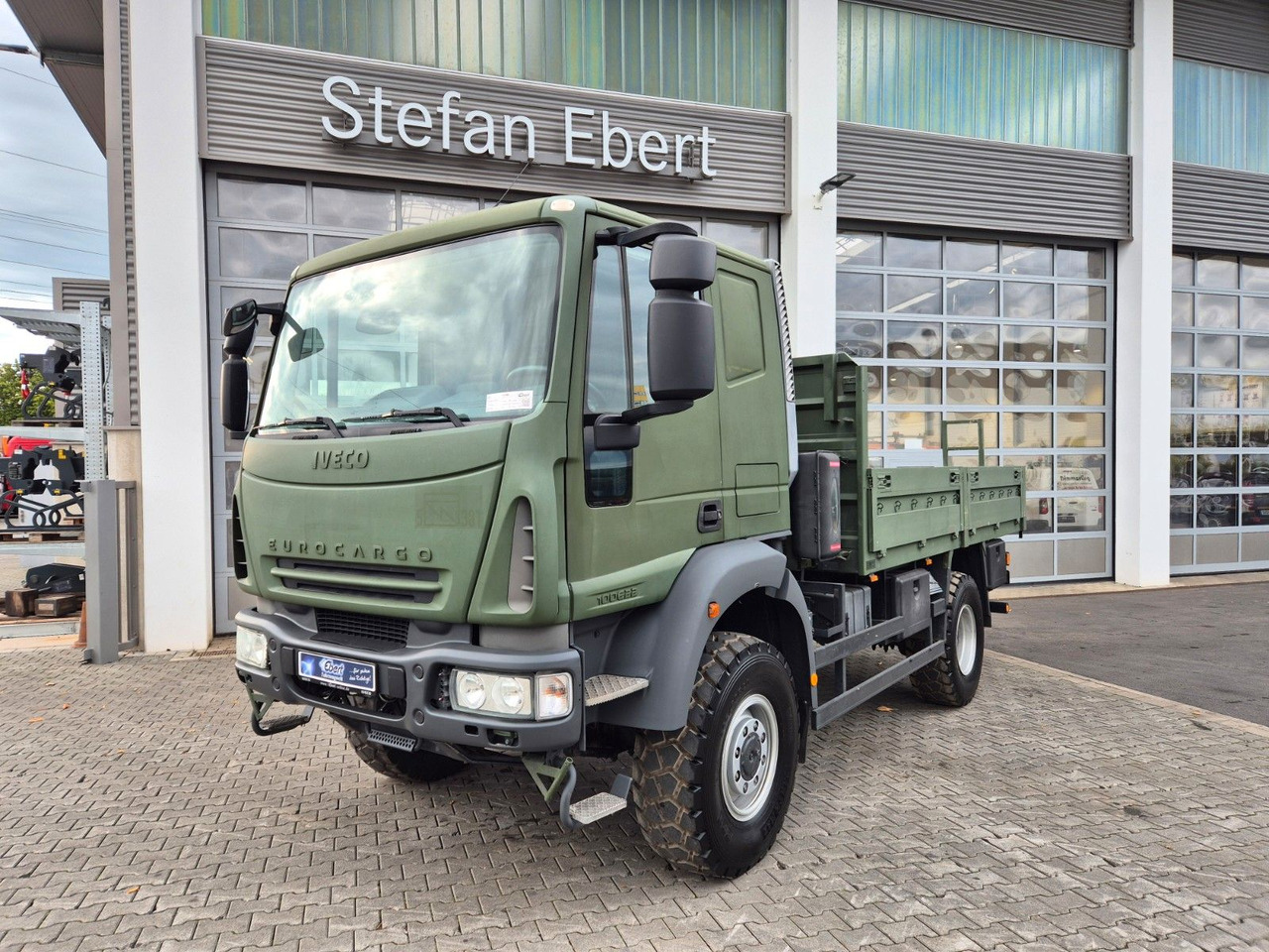 Iveco Eurocargo ML100E22WM-BW 4x4 Pritsche L-Haus Bett - Φορτηγό με ανοιχτή καρότσα: φωτογραφία 1 Iveco Eurocargo ML100E22WM-BW 4x4 Pritsche L-Haus Bett - Φορτηγό με ανοιχτή καρότσα: φωτογραφία 1